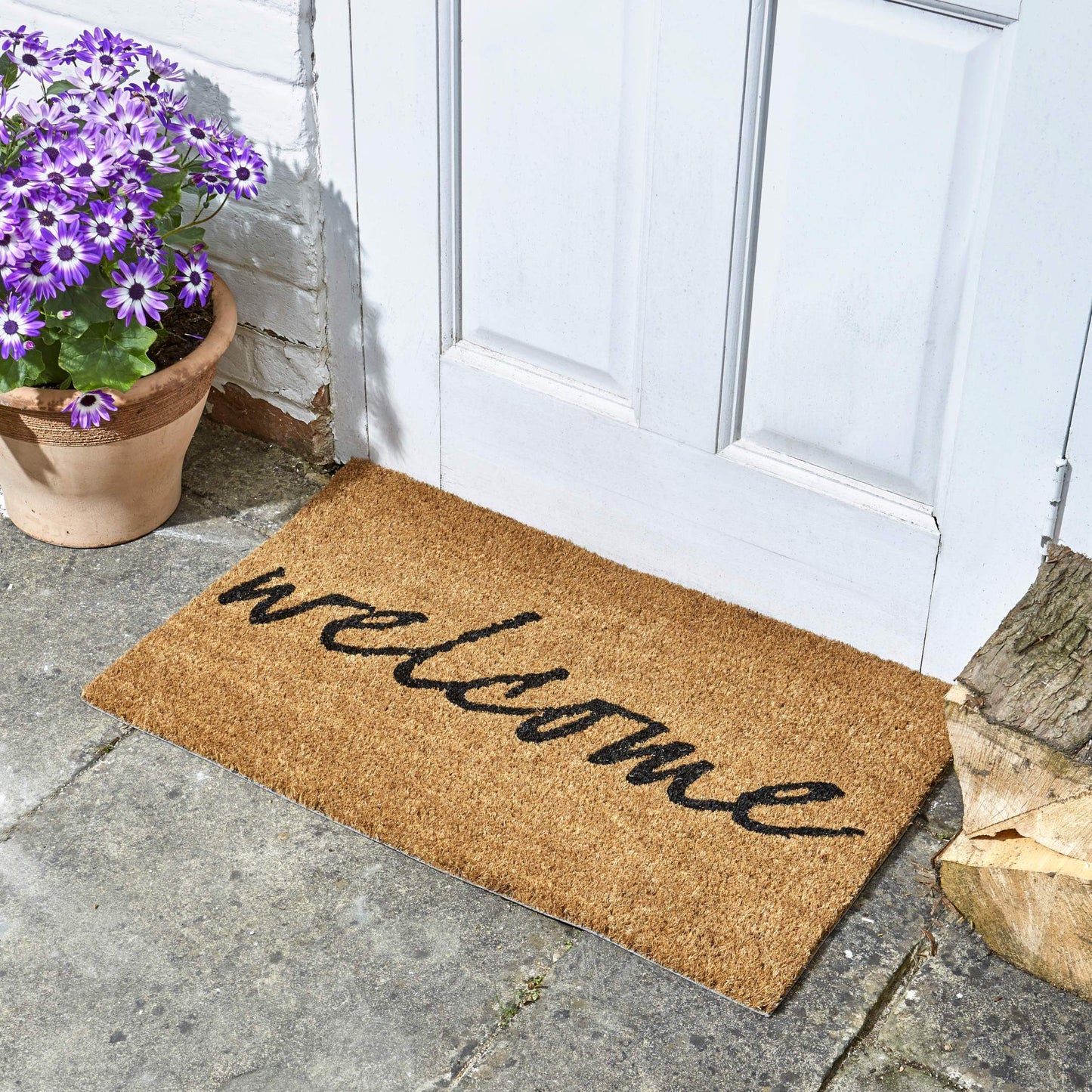Rohožka Welcome zo série Décoir pred vchodovými dverami